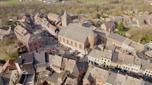 Catholic Church And Village Square With Crowd In Beaumont, Wallonia Belgium, Aerial Drone Shot