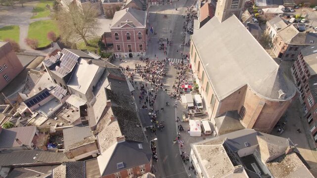 Crowd Gathering Around Church Square During Village Event In Small European Town, Busy Streets &ndash; Aerial Drone Shot