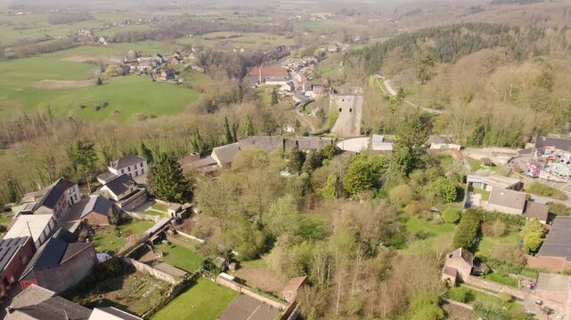 Aerial Orbit around Tour Salamandre Old Dungeon in Beaumont Belgium, Historic Stone Tower in Daylight with Surrounding Townscape - Drone Shot