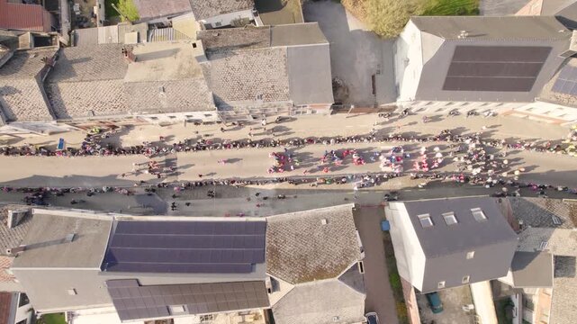 Community Event Parade On Street In Beaumont Village, Wallonia, Belgium. aerial topdown shot