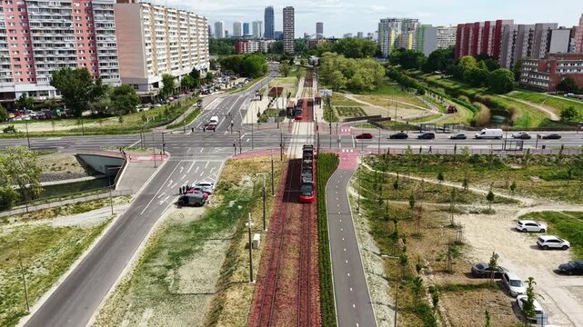 Aerial drone footage of modern tram line and residential district in Petržalka, Bratislava, Slovakia. Sustainable public transport, urban infrastructure and contemporary cityscape in summer.