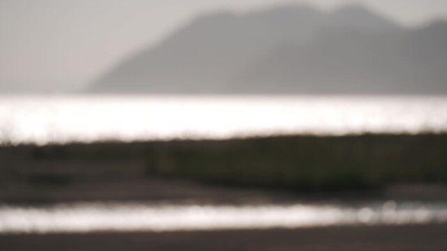Sandbar landscape at a river mouth with mountain ranges in the background of a deep inlet