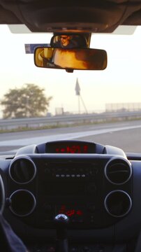 Car drive towards the sunset on highway view from inside slow motion