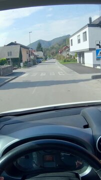 Person POV of driving the car through neighborhood