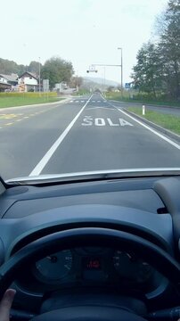 Driver POV of traveling through countryside village