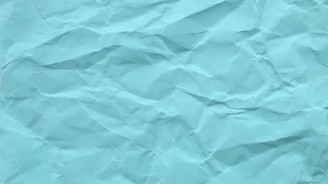 Bright light blue wrinkled paper texture seamless loop. Cool stop-motion animation for creative video overlays and airy backgrounds.
