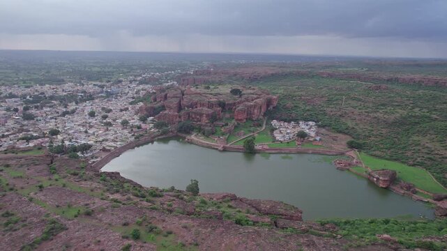 Drone view of Agastya Lake beside Badami Caves with scenic surroundings