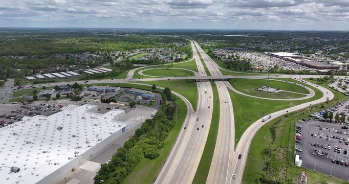 Aerial view of a highway interchange with traffic, commercial buildings, and parking lots in Columbus, Ohio, United States.