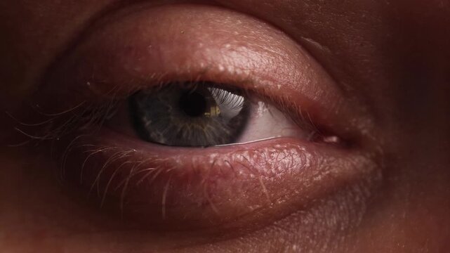 Extreme close-up of a human eye with detailed skin texture and iris patterns