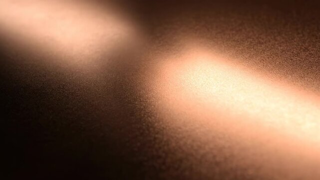 A textured, bronze-colored surface illuminated by a warm, diffused light