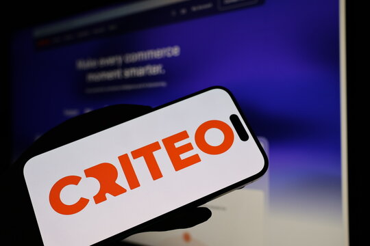 Kiel, Germany - 05-20-2026: Smartphone displaying French advertising technology company Criteo logo in front of companys webpage