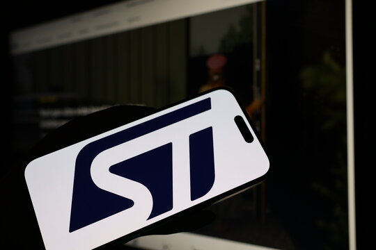 Kiel, Germany - 05-20-2026: Smartphone displaying Swiss semiconductor company STMicroelectronics logo in front of companys webpage