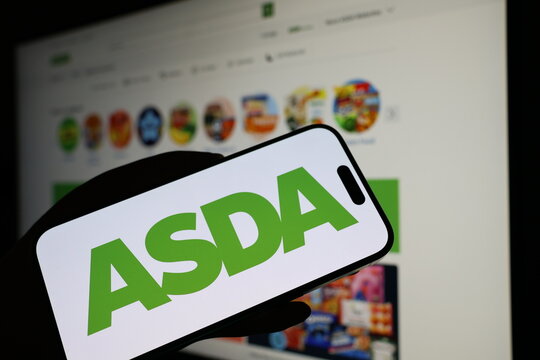 Kiel, Germany - 05-20-2026: Smartphone displaying British supermarket retail company Asda logo in front of companys webpage