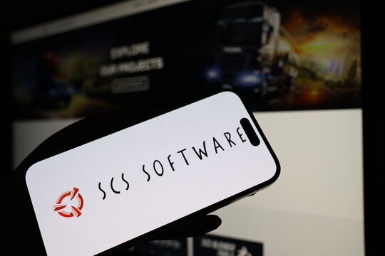 Kiel, Germany - 05-20-2026: Smartphone displaying Czech video game company SCS Software logo in front of companys webpage