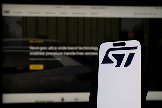 Kiel, Germany - 05-20-2026: Smartphone displaying Swiss semiconductor company STMicroelectronics logo in front of companys webpage