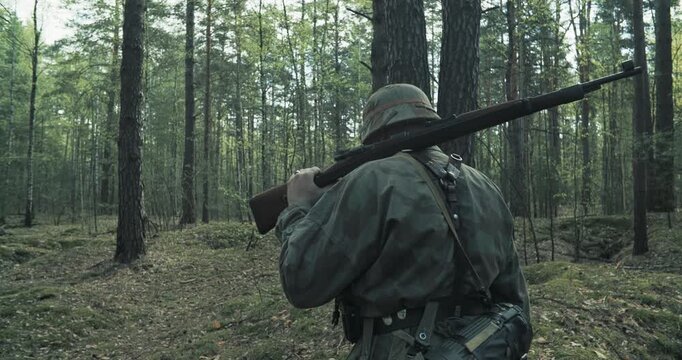 Reenactor Dressed As German Infantry Soldier Going By Forest In Slo-mo Slow
