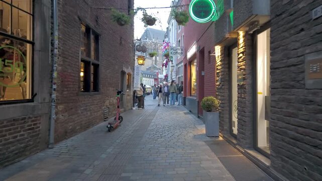 People Walking Through Historic Cobblestone Street in Old Town Aachen Germany - European Tourism Footage