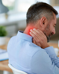 Fototapeta premium Man holds neck, showing pain. He's seated at a desk, looking tired. Red glow indicates discomfort. Office setting suggests stress or fatigue. This image captures daily strain