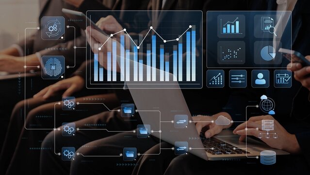 Modern business professionals analyze data trends using laptops and mobile devices in a collaborative office setting. Focus on analytics and teamwork. Raster