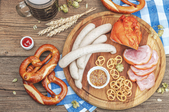 Traditional Oktoberfest set. Pretzels, beer, weisswurst, eisbein with mustard. German festival food