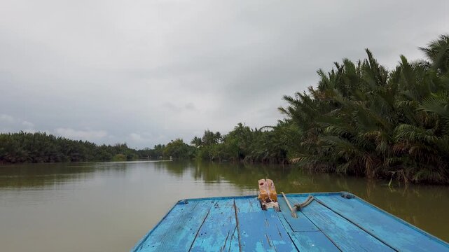 POV boat ride on tropical river with coconut trees Hoi An