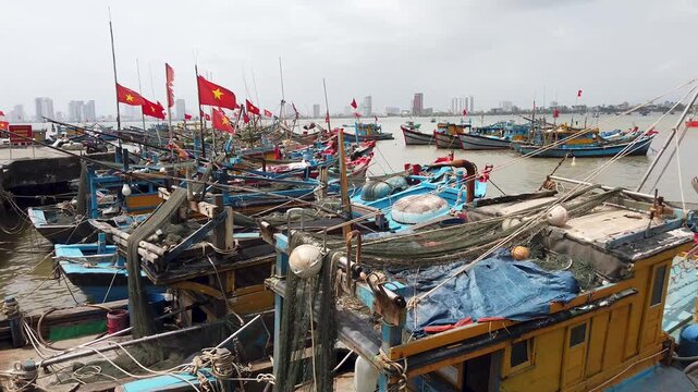 Fishing boats with Vietnam flags in coastal harbor Vietnam