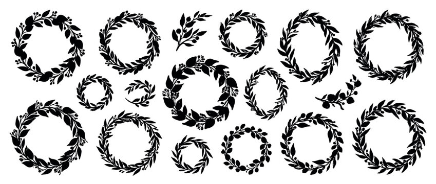 Large collection of black silhouette floral wreaths and branches with leaves and berries, hand-drawn in a rustic style for decorative graphic design elements and circular frames
