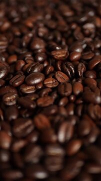 Rotating camera shot over a full frame background of roasted coffee beans