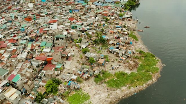 Slums in Manila near the port. River polluted with plastic and garbage. Manila, Philippines.