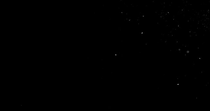 Super slow motion falling snow or dust particles isolated on a black background. Abstract atmospheric SFX overlay with floating debris, cinematic texture and dark visual effect.