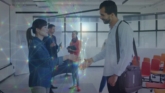 Man reaching to shake woman's hand, greeting peers in training, prism overlay accenting handshake