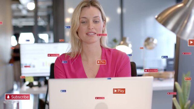Woman at desk turning toward laptop while Play Subscribe badges appearing, guiding marketing focus