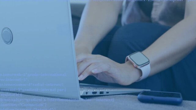 Woman responding to code overlay appearing over hands, moving to keyboard and typing for coding