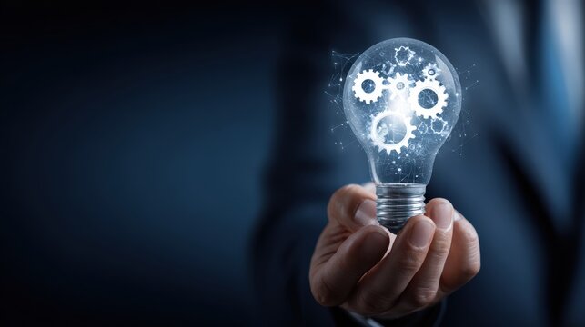 A hand holding a glowing light bulb filled with intricate gears, symbolizing innovation and the creation of ideas in a business context. ..Created with Generative AI, not depicting real subjects.