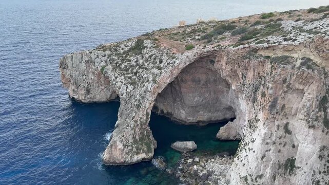 Scenic view of the famous Blue Grotto sea cave in Malta with turquoise water