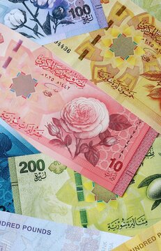 Syrian pound money banknotes bunch on table. Syria bills of SYP currency close up