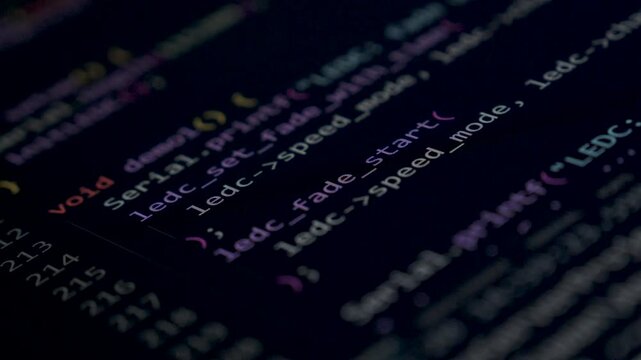 Coding programs on black screen background.