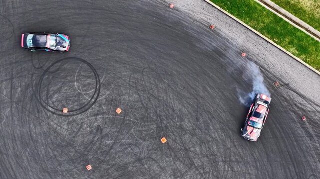 Aerial top view of sports cars drifting and racing