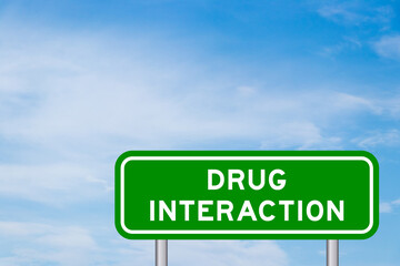 Green color transportation sign with word drug interaction on blue sky with white cloud background