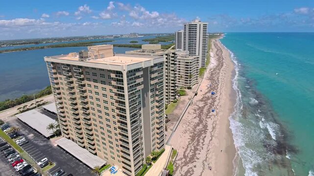 Aerial view of high-rise beachfront condominiums and sandy shores on Singer Island in Riviera Beach, Florida, United States.