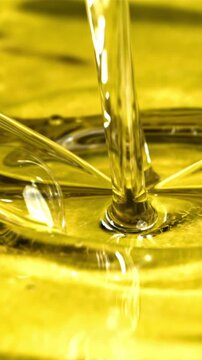 Olive oil with splashes on yellow background. Filmed on a high-speed camera at 1000 fps. High quality FullHD footage
