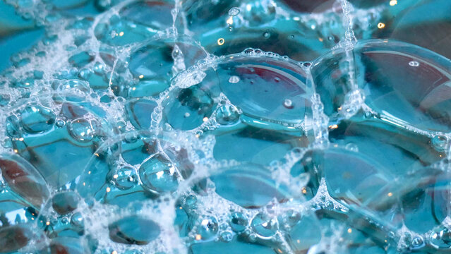 Close-up of Transparent Bubbles and Foam on Blue Water Surface in Chonburi