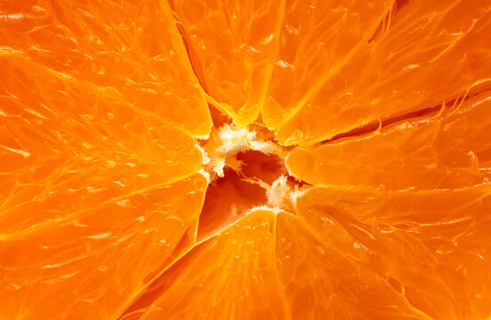 Detailed Close-Up of Juicy Orange Slices Concentric,An ultra-detailed, macro photograph capturing the glistening, juice-filled vesicular segments and fibrous central core of a cross-sectioned fresh.