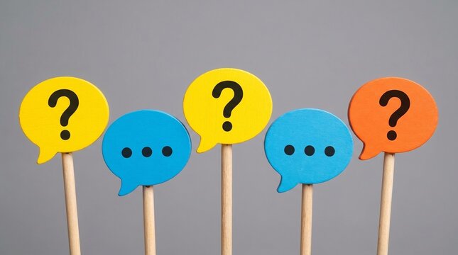 Colorful speech bubble signs with question marks and ellipsis symbols placed in alternating sequence over gray background to express communication uncertainty and inquiry concepts.