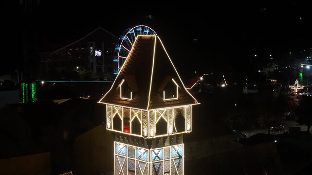Night View Of Capivari Village In Campos Do Jordao In Sao Paulo Brazil. Illuminated Ferris Wheel. Downtown Cityscape. European Architecture. Capivari Village In Campos Do Jordao In Sao Paulo Brazil. 