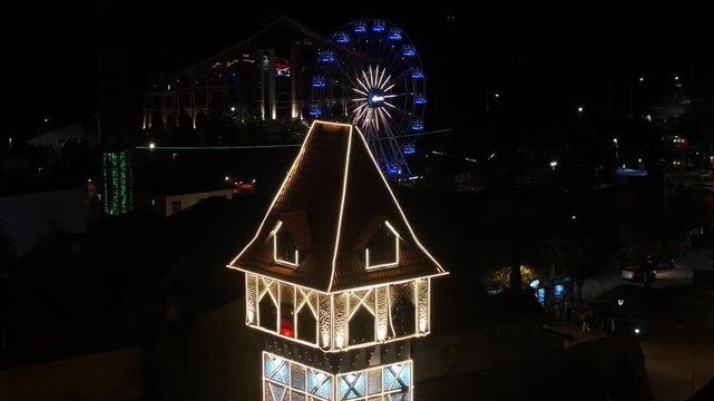 Night View Of Capivari Village In Campos Do Jordao In Sao Paulo Brazil. Illuminated Ferris Wheel. Downtown Cityscape. European Architecture. Capivari Village In Campos Do Jordao In Sao Paulo Brazil. 