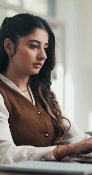 Serious, woman or typing on laptop in office for bookkeeping, financial report or filing tax return. Corporate, accountant and tech at firm for payroll processing, online finance query and research
