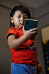 Toddler Using Smartphone To Call His Mother In The Room