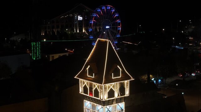Night View Of Capivari Village In Campos Do Jordao In Sao Paulo Brazil. Illuminated Ferris Wheel. Downtown Cityscape. European Architecture. Capivari Village In Campos Do Jordao In Sao Paulo Brazil. 