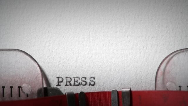 Press release message concept written with a typewriter in a white paper